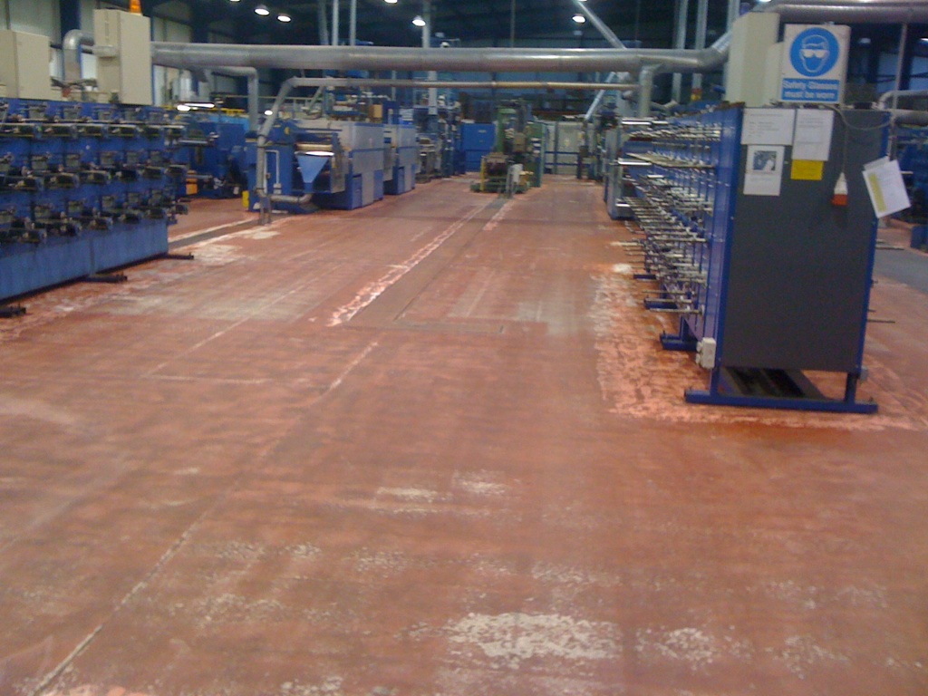 Factory floor before: worn concrete